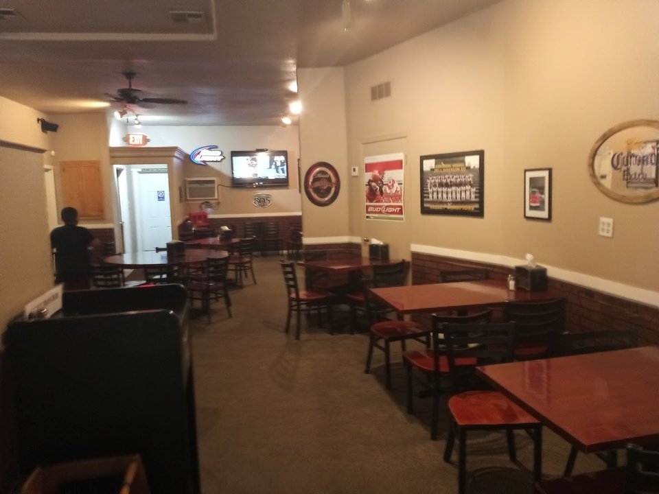 Pizza restaurant dining room with tables and chairs.
